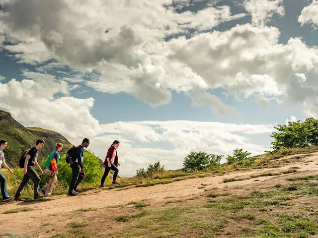 A group of students climbing Arthur's Seat in Edinburgh.