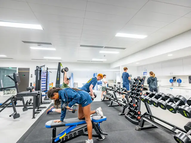 A group of students using weights in the Oriam gymnasium