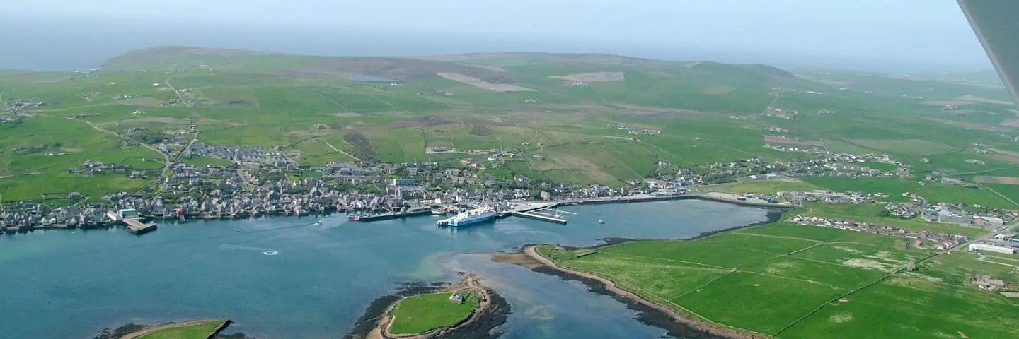 A faraway view of Orkney town and coastline