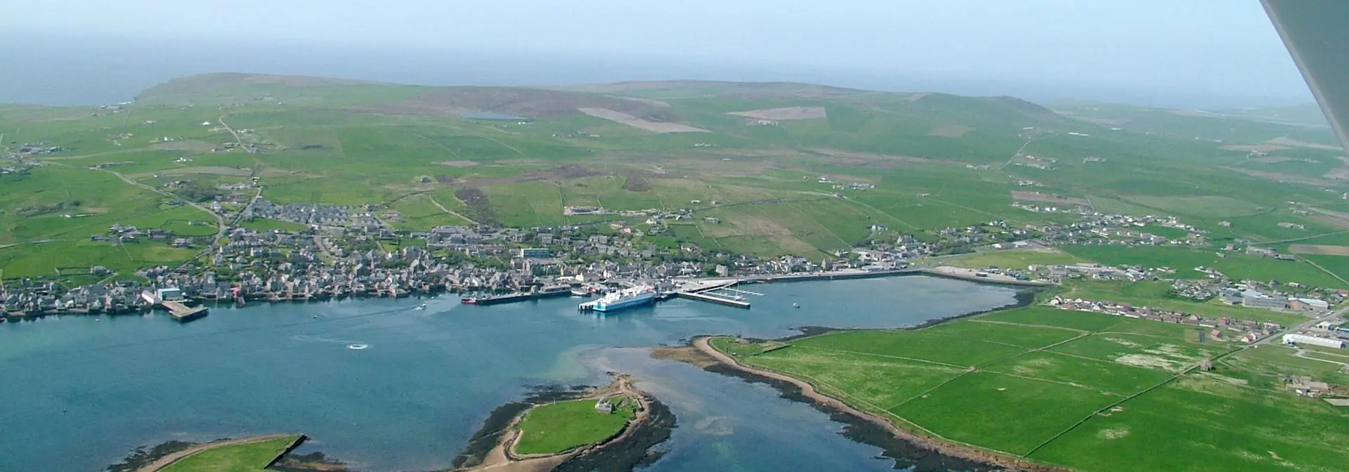 A faraway view of Orkney town and coastline