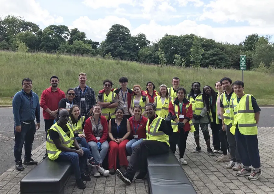 Group of people wearing high vis uniforms standing together.