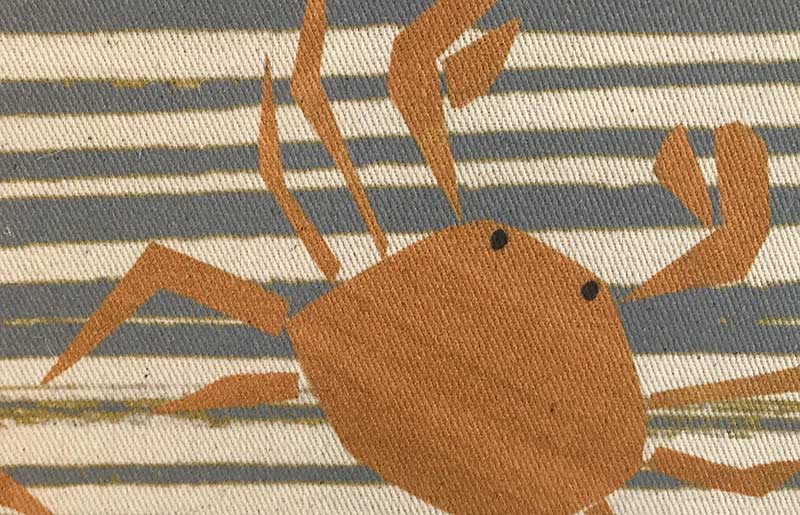 blue and cream striped linen with an orange crab printed on