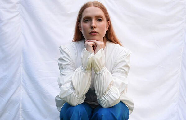 female red hair sitting white jacket