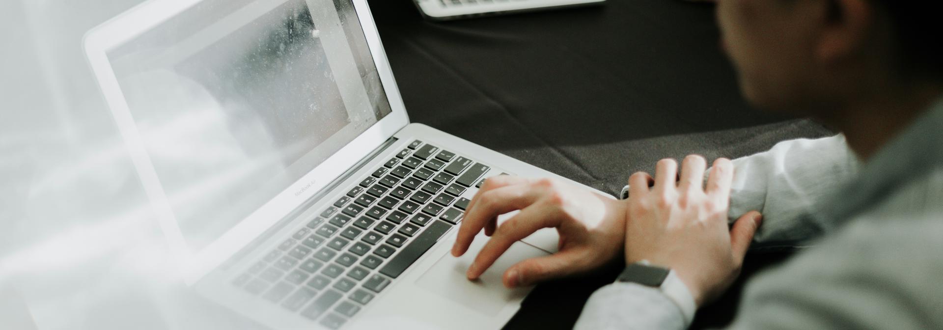 A student looking at the laptop screen