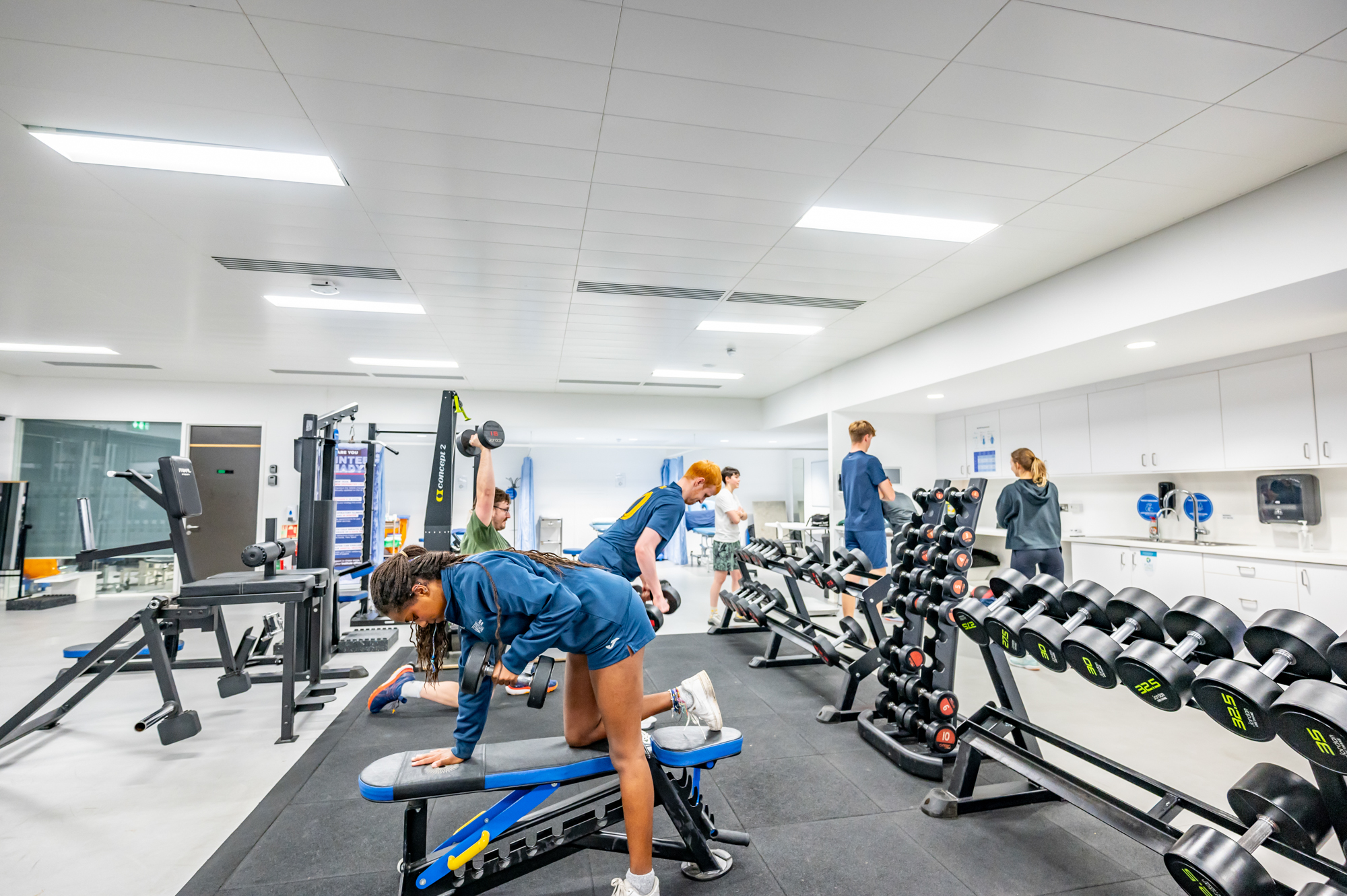 A group of students using weights in the Oriam gymnasium