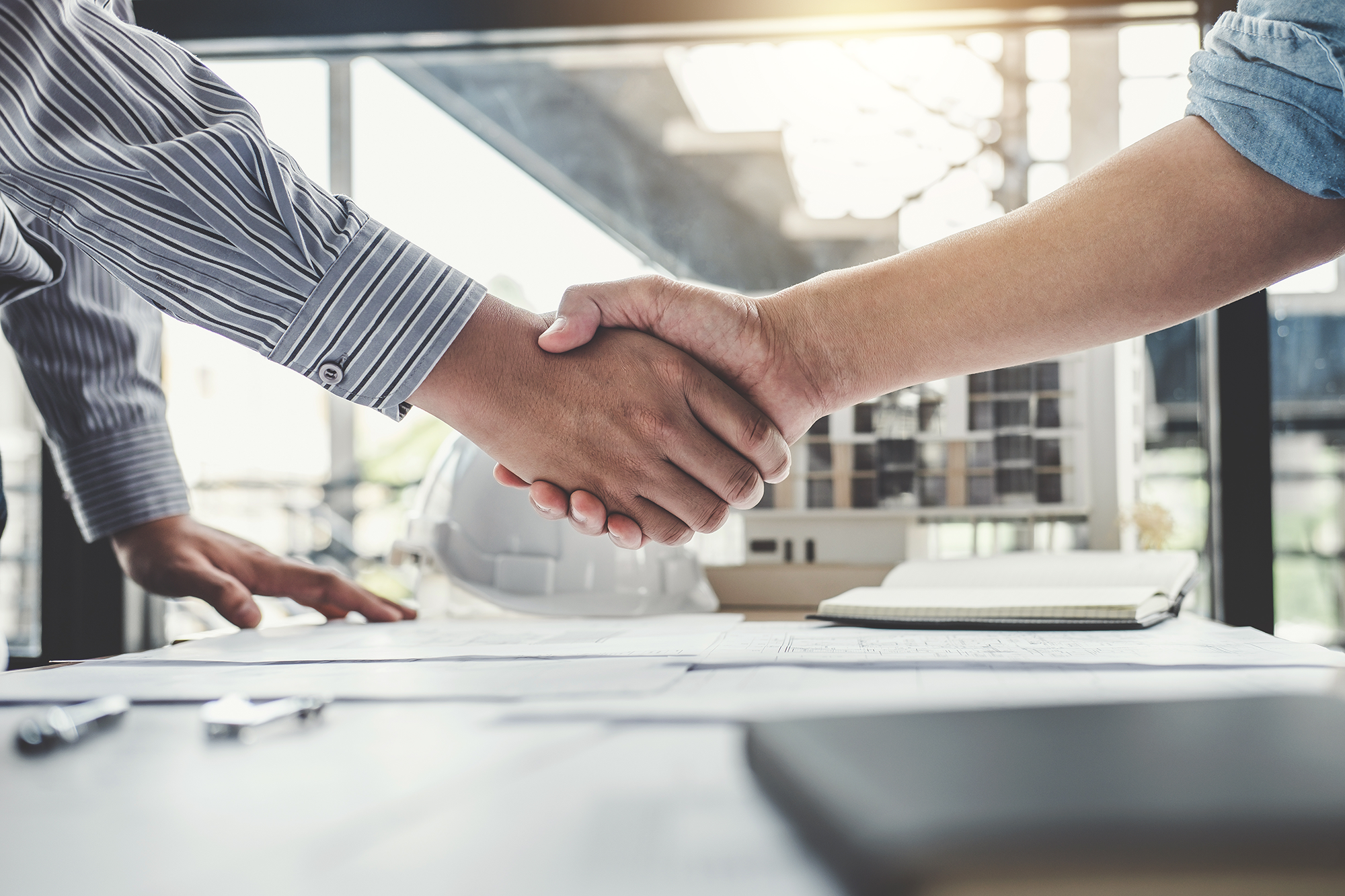 Two workers in industry shaking hands