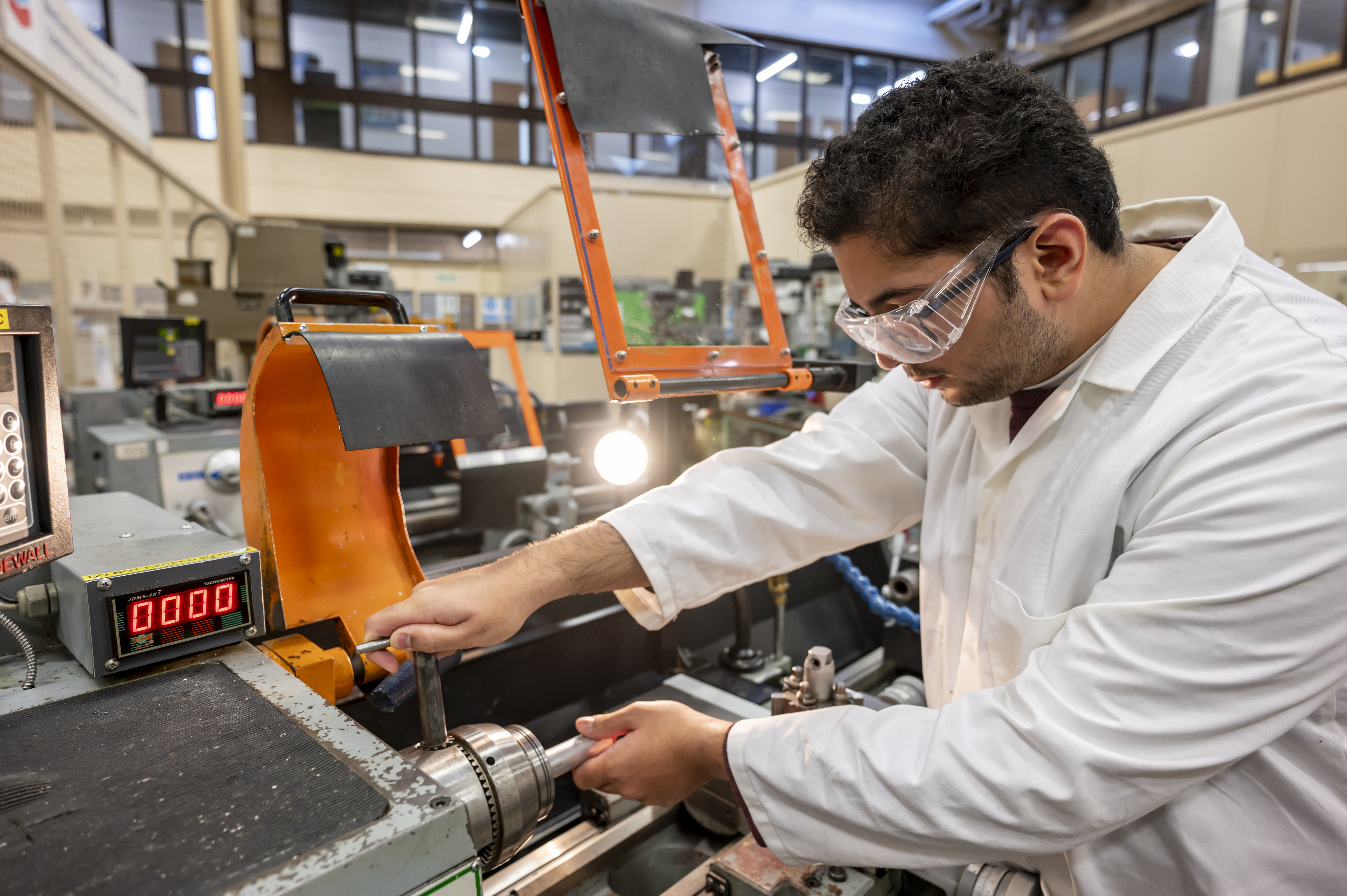 Student working with machinery in EPS. 