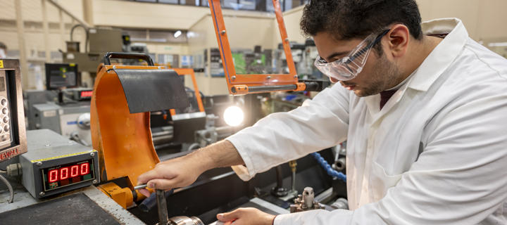 Student working with machinery in EPS.