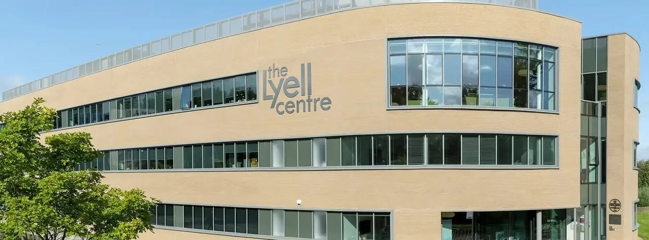 The Lyell Centre building surrounded by green lawn and trees under a blue sky.