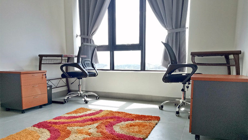 Study area with two desks and chairs, bright rug and big window
