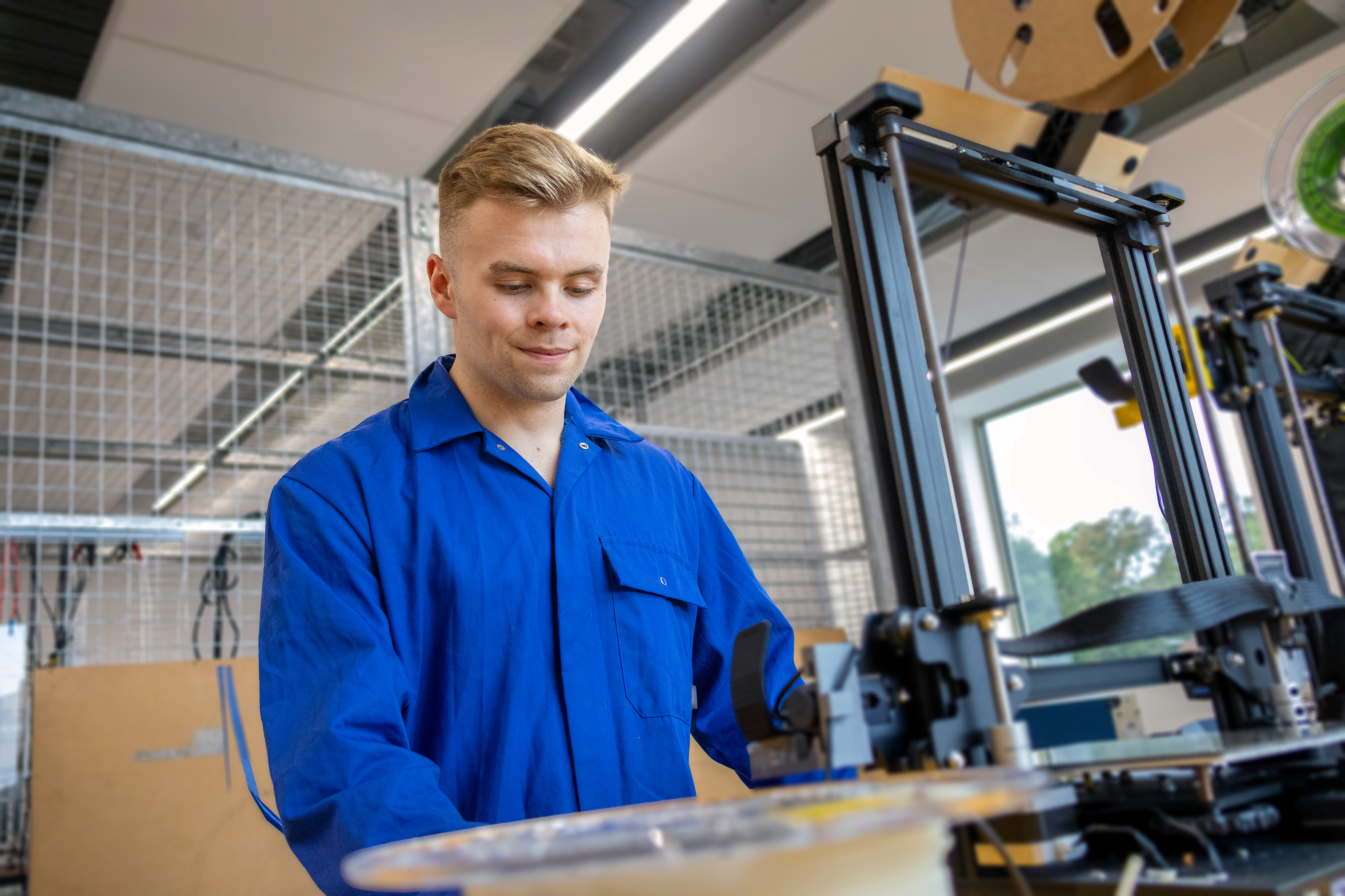 Kyle, mechanical engineering student, creating with the laser cutter machine