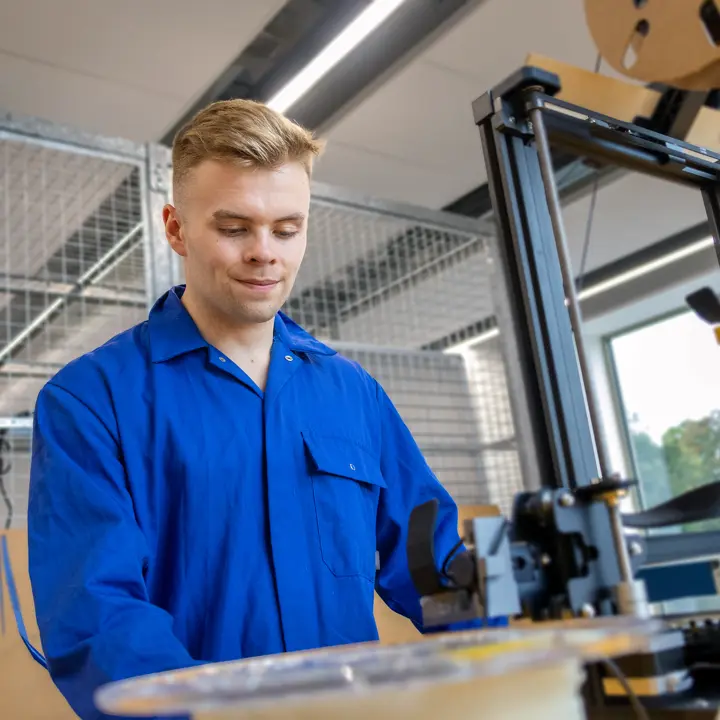 Kyle, mechanical engineering student, creating with the laser cutter machine
