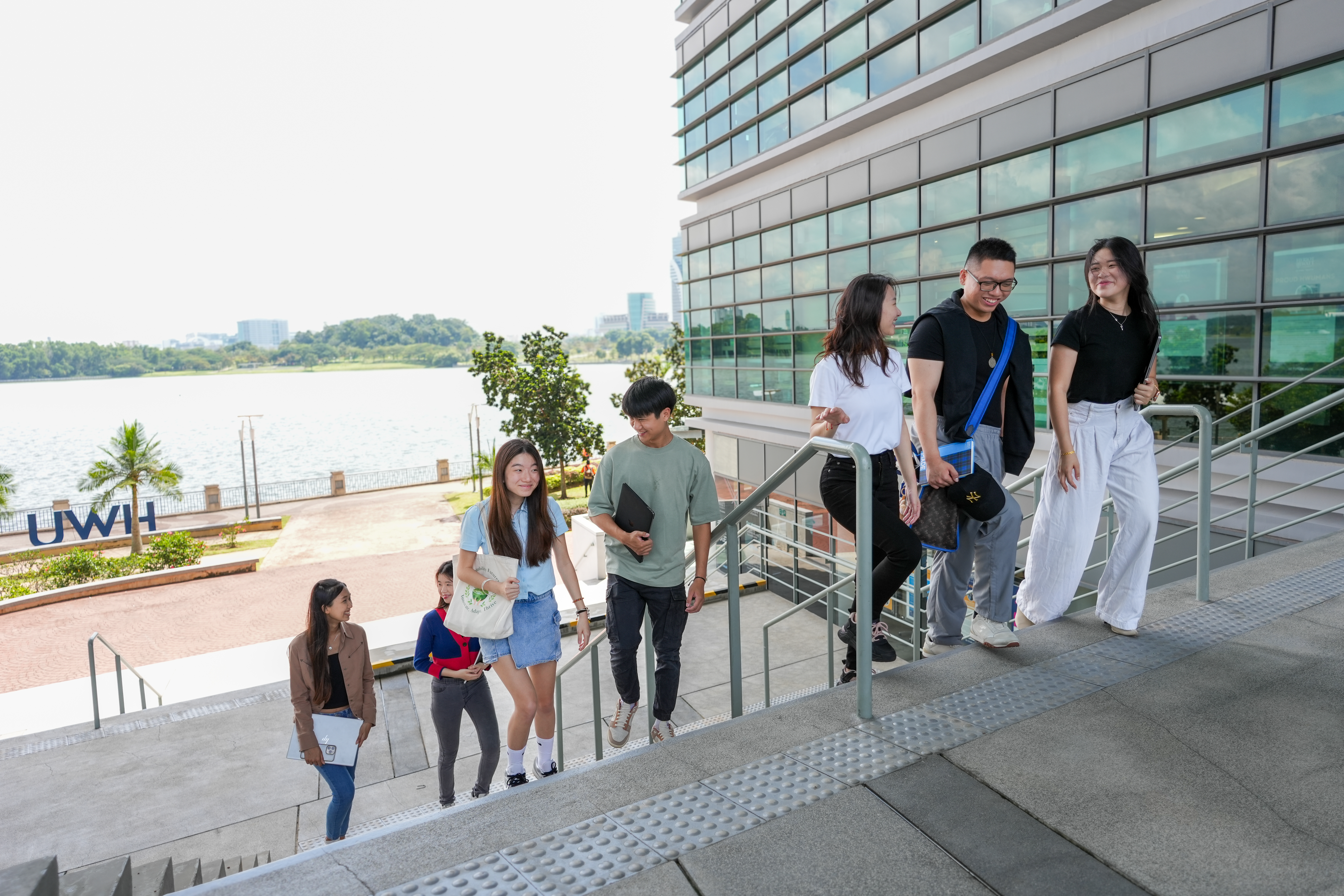 Students at Heriot-Watt University Malaysia walking up the steps at the campus. 