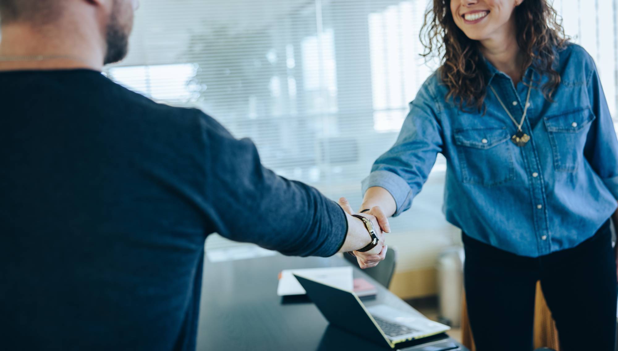 Two people meet and shaking hands.