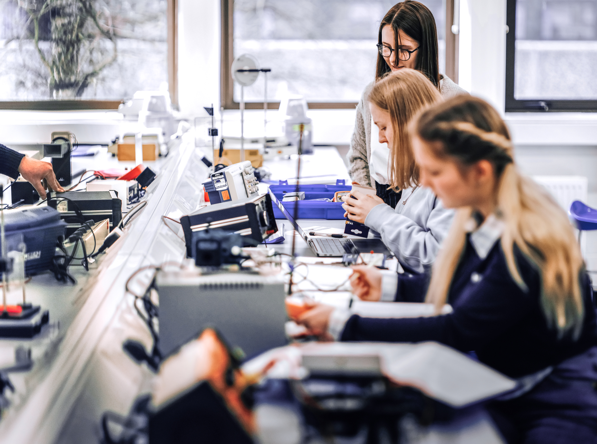 Female physics students working on electrical current experiment