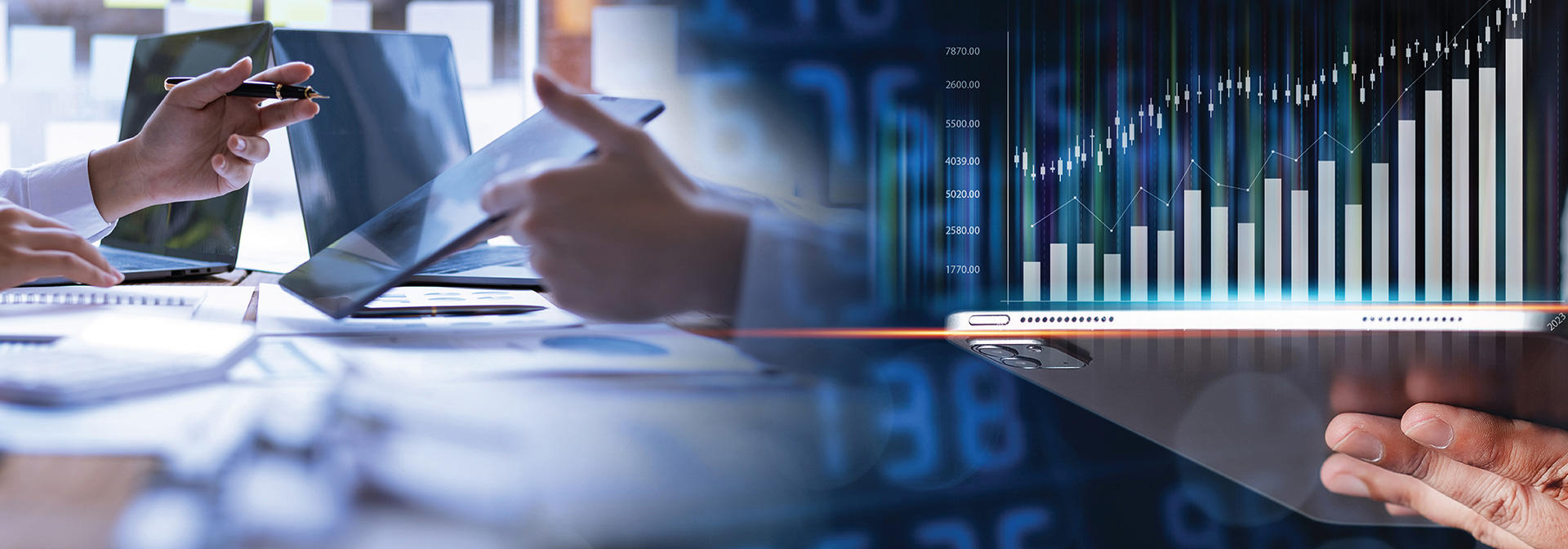 Two colleagues review a digital display featuring graphs and numerical information.