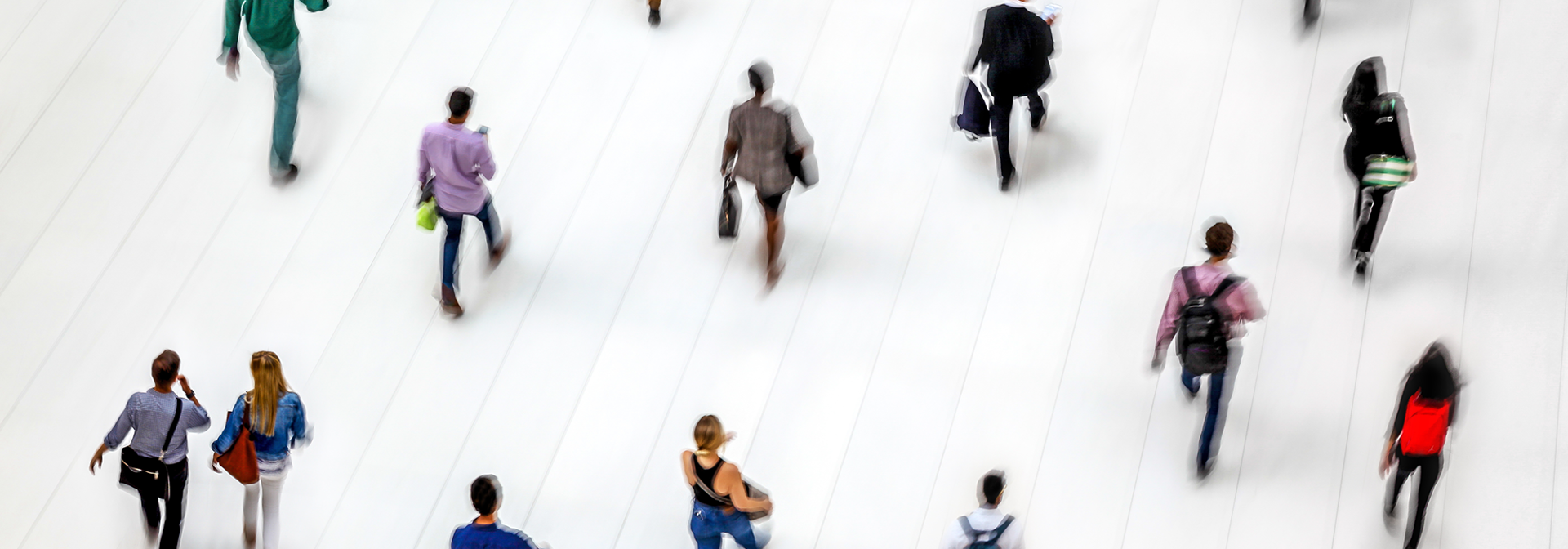 People walking in a white-tiled hall