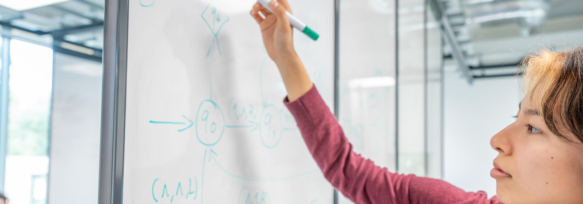 Student writing on a whiteboard