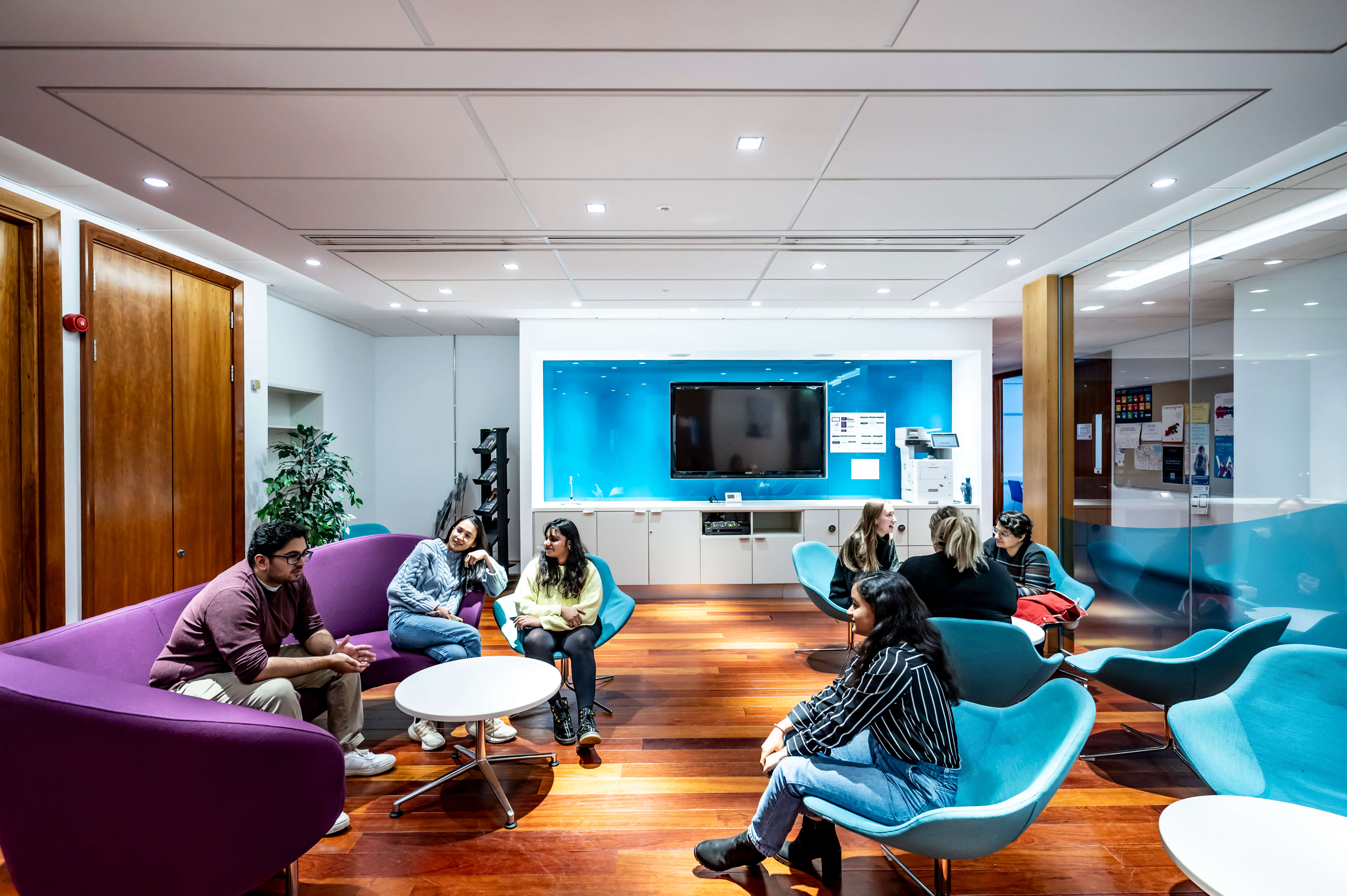 Students sit in the Lumsden Suite break out area at Edinburgh Business School