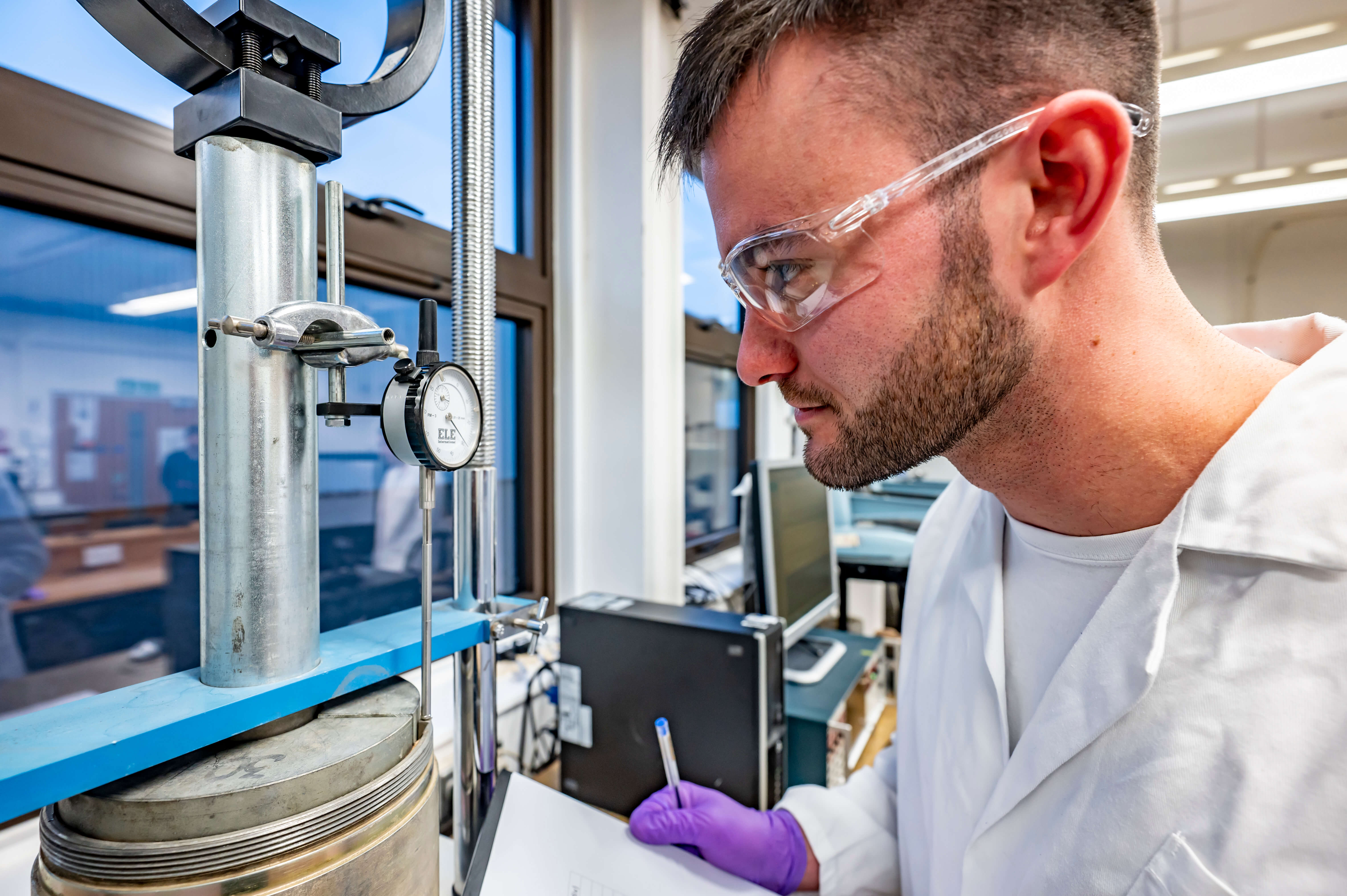 A student takes readings from a pressure gauge