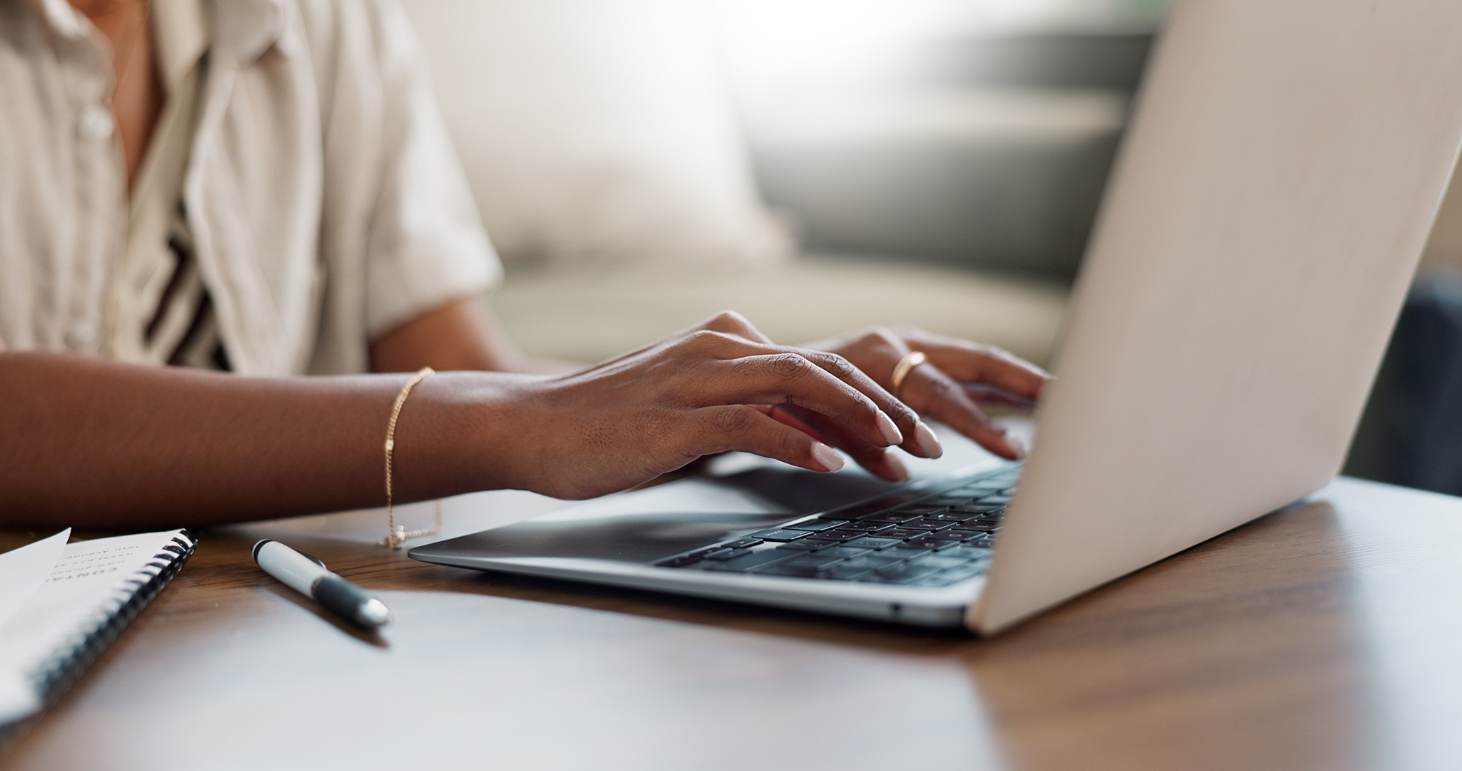 hands typing on laptop